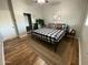 Charming bedroom with wood floors, a large bed, and stylish wall decor at 8114 E Clarendon Ave, Scottsdale, AZ 85251