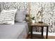 Cozy bedroom detail with patterned wallpaper and nightstand at 8114 E Clarendon Ave, Scottsdale, AZ 85251