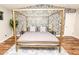 Bedroom with a gold canopy bed and patterned wallpaper at 8114 E Clarendon Ave, Scottsdale, AZ 85251