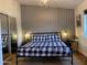 Bright bedroom featuring a king-size bed and geometric wallpaper at 8114 E Clarendon Ave, Scottsdale, AZ 85251