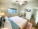 Bedroom with a large bed and wood floors at 8114 E Clarendon Ave, Scottsdale, AZ 85251