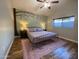 Main bedroom with tree mural and metal bed frame at 8114 E Clarendon Ave, Scottsdale, AZ 85251