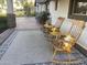 Inviting front porch with rocking chairs and a rug at 8114 E Clarendon Ave, Scottsdale, AZ 85251