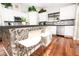 Modern kitchen with white cabinets and a stylish breakfast bar at 8114 E Clarendon Ave, Scottsdale, AZ 85251