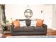 Living room with dark couch and circular shelf at 8114 E Clarendon Ave, Scottsdale, AZ 85251
