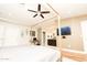 Spacious main bedroom with a large bed, en-suite bathroom, and a home office at 8114 E Clarendon Ave, Scottsdale, AZ 85251