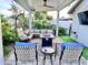 Covered patio with seating area, fire pit, and outdoor TV at 8114 E Clarendon Ave, Scottsdale, AZ 85251