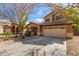 Two-story house with tan exterior, two-car garage, and landscaping at 835 E Marigold Pl, San Tan Valley, AZ 85143