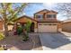Two-story house with a tan exterior, two-car garage, and landscaping at 835 E Marigold Pl, San Tan Valley, AZ 85143