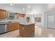 Kitchen with island, stainless steel appliances, and wood cabinets at 835 E Marigold Pl, San Tan Valley, AZ 85143