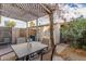 Relaxing patio with pergola, storage shed, and lush landscaping at 1029 E Lodge Dr, Tempe, AZ 85283