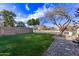 Backyard with grassy lawn, trees, and rock border at 10760 W Monte Vista Rd, Avondale, AZ 85392