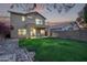 Spacious backyard with grassy area, fire pit, and covered patio at 10760 W Monte Vista Rd, Avondale, AZ 85392