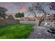 Backyard with grassy lawn, fire pit, and water view at 10760 W Monte Vista Rd, Avondale, AZ 85392