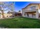 Large backyard with grassy area, fire pit, and patio at 10760 W Monte Vista Rd, Avondale, AZ 85392