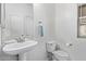Clean bathroom with pedestal sink and toilet at 10760 W Monte Vista Rd, Avondale, AZ 85392