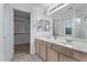 Double vanity bathroom with a walk-in closet at 10760 W Monte Vista Rd, Avondale, AZ 85392