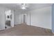 Bedroom with carpet flooring and access to bathroom and hallway at 10760 W Monte Vista Rd, Avondale, AZ 85392