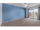 Bright bedroom with balcony access and blue accent wall at 10760 W Monte Vista Rd, Avondale, AZ 85392