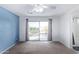 Spacious bedroom with balcony access and blue accent wall at 10760 W Monte Vista Rd, Avondale, AZ 85392
