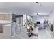 Dining area with a wooden table, chairs, and an open kitchen view at 10760 W Monte Vista Rd, Avondale, AZ 85392