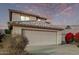 Two-story house with beige walls, tile roof, and a two-car garage; desert landscaping at 10760 W Monte Vista Rd, Avondale, AZ 85392