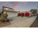 Two-story house with beige walls and a two-car garage; red flowering bushes at 10760 W Monte Vista Rd, Avondale, AZ 85392