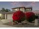 Two-story house with beige walls, tile roof, and a two-car garage; red flowers at 10760 W Monte Vista Rd, Avondale, AZ 85392