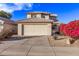 Two-story house with beige walls, tile roof, and a two-car garage at 10760 W Monte Vista Rd, Avondale, AZ 85392