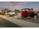 Two-story house with beige walls and a two-car garage; red flowering bushes at 10760 W Monte Vista Rd, Avondale, AZ 85392
