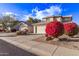 Two-story house with attached garage and vibrant landscaping at 10760 W Monte Vista Rd, Avondale, AZ 85392