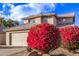 Two-story house with beige walls, tile roof, and a two-car garage at 10760 W Monte Vista Rd, Avondale, AZ 85392
