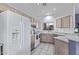 Kitchen with white appliances and light wood cabinets at 10760 W Monte Vista Rd, Avondale, AZ 85392