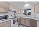 Bright kitchen features white appliances and light wood cabinets at 10760 W Monte Vista Rd, Avondale, AZ 85392
