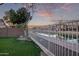 Backyard with water view, grassy area, and metal fence at 10760 W Monte Vista Rd, Avondale, AZ 85392