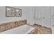 Elegant bathroom with soaking tub, marble tile, and separate shower at 10769 N 113Th St, Scottsdale, AZ 85259