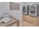 Laundry room with washer, dryer, and folding table at 10769 N 113Th St, Scottsdale, AZ 85259