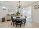 Dining room with round table, black chairs, and large window at 10994 W Mckinley St, Avondale, AZ 85323