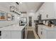 White kitchen with island, stainless steel appliances, and pantry at 10994 W Mckinley St, Avondale, AZ 85323