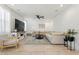 Spacious living room with sectional sofa, large TV, and ceiling fan at 10994 W Mckinley St, Avondale, AZ 85323