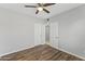 Bright bedroom with ceiling fan, wood-look floors, and ample closet space at 1423 E Cholla St, Phoenix, AZ 85020