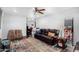 Living room with brown leather sofas, a ceiling fan, and area rug at 1424 S Temple Cir, Mesa, AZ 85204