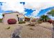 House exterior showcasing desert landscaping and a covered patio at 15253 W Pasadena Dr, Surprise, AZ 85374