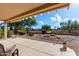 Desert landscaping with covered patio, and view of the mountains at 15253 W Pasadena Dr, Surprise, AZ 85374