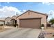 Single-story home with desert landscaping and two-car garage at 15253 W Pasadena Dr, Surprise, AZ 85374