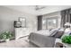 Main bedroom with king bed and window seating at 15253 W Pasadena Dr, Surprise, AZ 85374