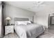 Main bedroom with king-size bed and ceiling fan at 15253 W Pasadena Dr, Surprise, AZ 85374