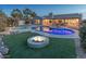 Expansive backyard oasis with pool, spa, and fire pit at 15538 W Whitton Ave, Goodyear, AZ 85395