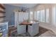 Bright dining area with a table and chairs, built-in shelving, and large windows at 15538 W Whitton Ave, Goodyear, AZ 85395