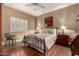 Charming bedroom with wood floors and a floral bedspread at 16450 E Ave Of The Fountains -- # 23, Fountain Hills, AZ 85268